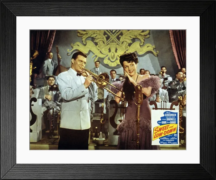Framed Print : Lobby card for SWEET AND LOW-DOWN, showing stars Benny Goodman (1909-1986), playing trombone, and Linda Darnell (1921-1956), on stage with Goodman's band. 1944