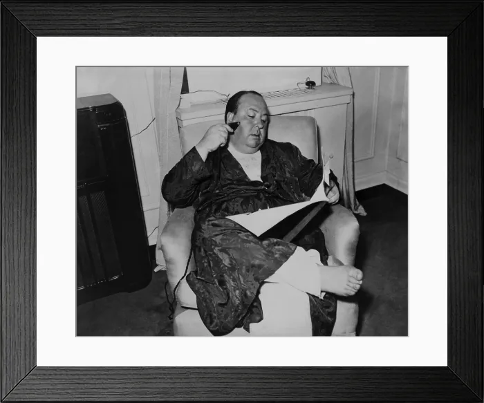 Framed Print : Alfred Hitchcock, seated in a recliner, shaving and reading while in his pajamas and robe, 1938. (BSLOC_2013_8_272) Framed Print : Alfred Hitchcock, seated in a recliner, shaving and reading while in his pajamas and robe, 1938. (BSLOC_2013_8_272)