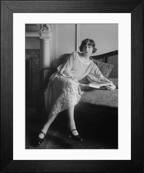 Framed Print : Actress Fanny Brice, with open book, seated on sofa, c. 1920-25