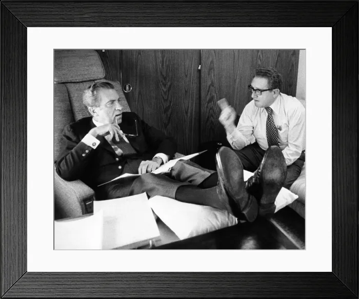 Framed Print : President Richard Nixon and Henry Kissinger talking on Air Force One. Nixon's multi-nation travel from June 10-19 provided little distraction from the Watergate Scandal