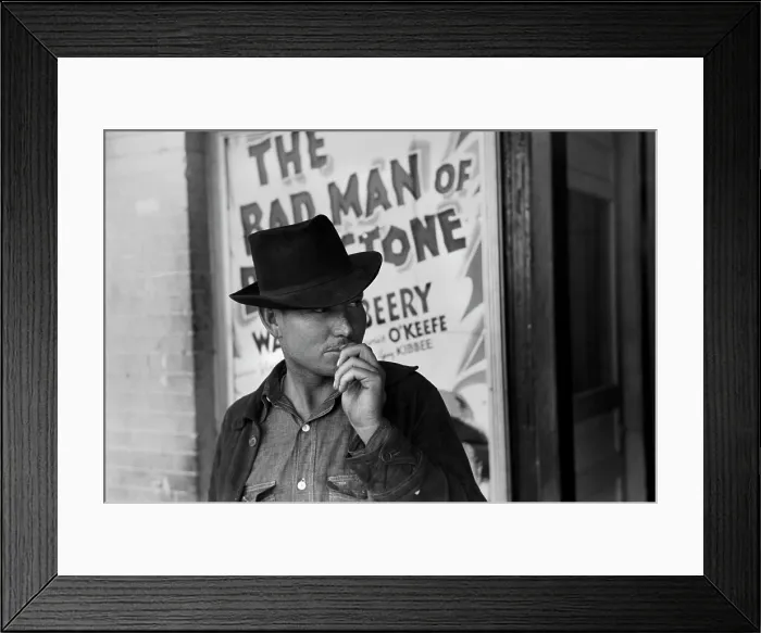 Framed Print : Man in front of a movie theater playing THE BAD MAN OF BRIMSTONE, Waco, Texas, photograph by Lee Russell, 1939 Framed Print : Man in front of a movie theater playing THE BAD MAN OF BRIMSTONE, Waco, Texas, photograph by Lee Russell, 1939