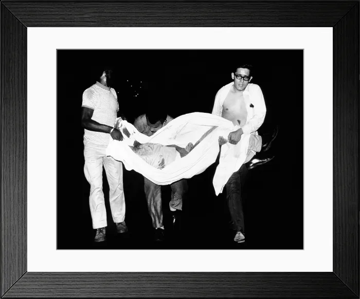 Framed Print : Three men carry body of a youth who died after apparently falling from a rooftop during third night of civil disorder in Spanish Harlem on July 25, 1967