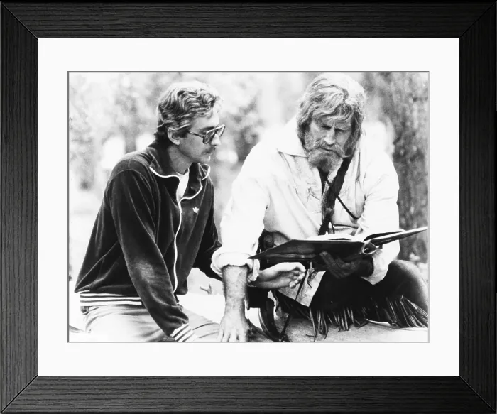 Framed Print : Screenwriter Fraser Clark Heston (left) discusses a scene with his father, Charlton Heston. They were on the set of Columbia Pictures THE MOUNTAIN MEN, which Fraser wrote. 1980