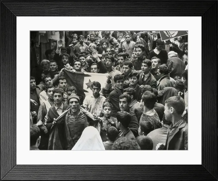 Framed Print : Algeria (1959). Young Algerians unfurl the Algerian flat during a cease-fire in the Kasbah of Algiers. AISA / Everett Collection**US SALES ONLY** Framed Print : Algeria (1959). Young Algerians unfurl the Algerian flat during a cease-fire in the Kasbah of Algiers. AISA / Everett Collection**US SALES ONLY**