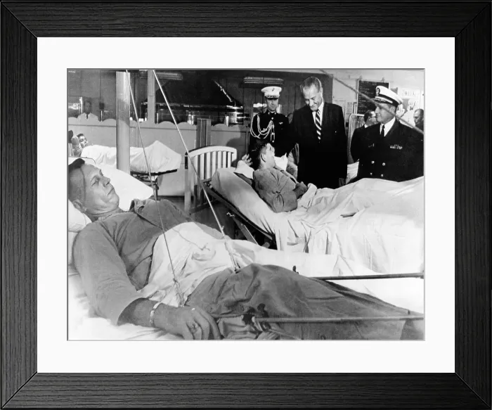 Framed Print : President Lyndon Johnson visits Vietnam wounded. Johnson chats with Cpl. Ronald Ortiz as 1st Lt. Bernard VeRonin, lying in traction in the foreground, awaits his turn