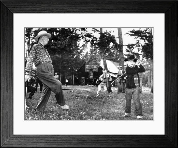 Framed Print : President Eisenhower adds a little body English to David Eisenhower's golf swing. David is being tutored in golf during a family vacation in Fraser, Colo