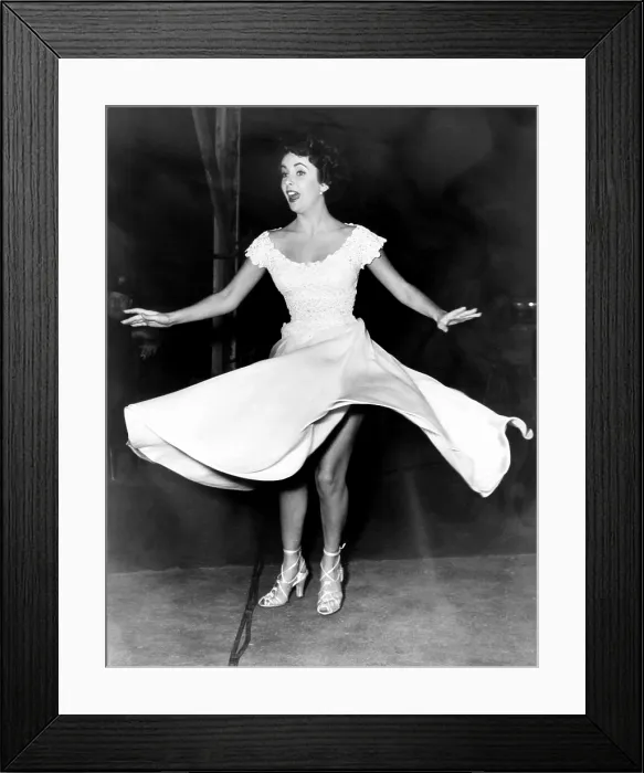 Framed Print : A PLACE IN THE SUN, Elizabeth Taylor, giving her Edith Head dress a twirl during a portrait sitting, February 1950