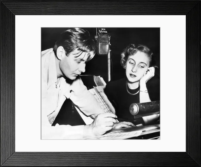 Framed Print : Margaret Truman, singing daughter of the President, recording her first album. With her director, Robert Shaw, she reviews music in the RCA recording studio. Nov. 10, 1950