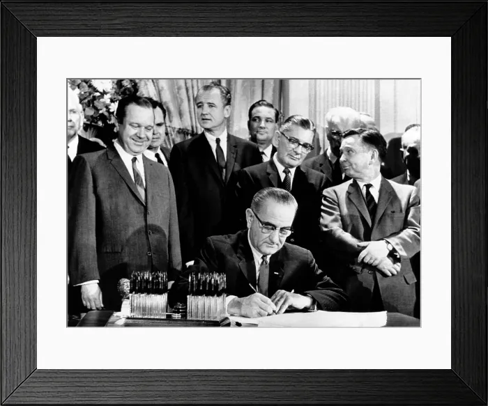 Framed Print : President Lyndon Johnson signs a $11.5 billion tax cut bill. Standing, L-R: Russell Long; Al Ullman; George Smathers; Pat Jennings; Wilbur Mills; John McCormack; Carl Albert. Feb