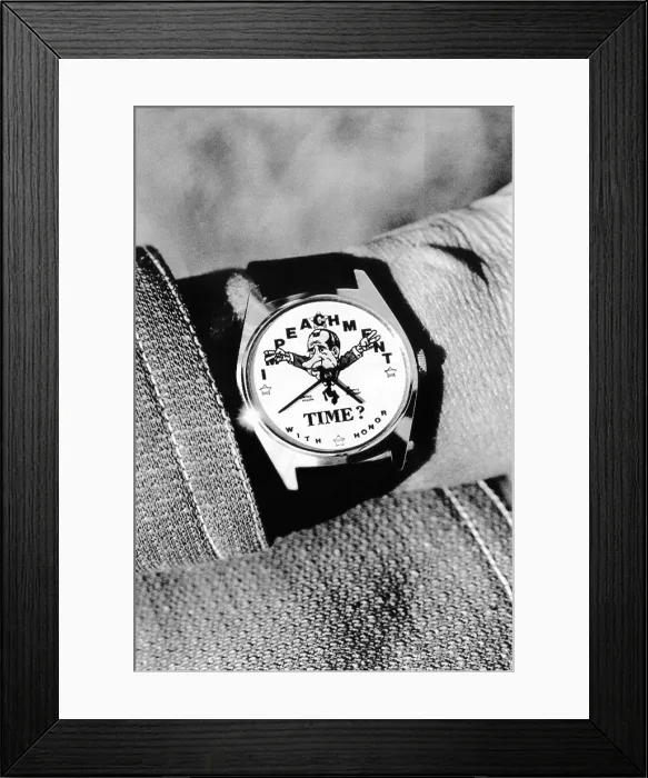 Framed Print : Watergate souvenir watch. The Impeachment Time watch, features a caricature of Pres. Nixon with his hands raised in the familiar two-finger salute. May 28, 1974