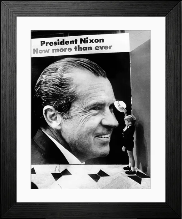 Framed Print : A four-year-old boy, tips his hat to a huge poster of President Nixon at the Fountainbleau Hotel. Above the image reads, President Nixon, Now more than ever. August 18, 1972