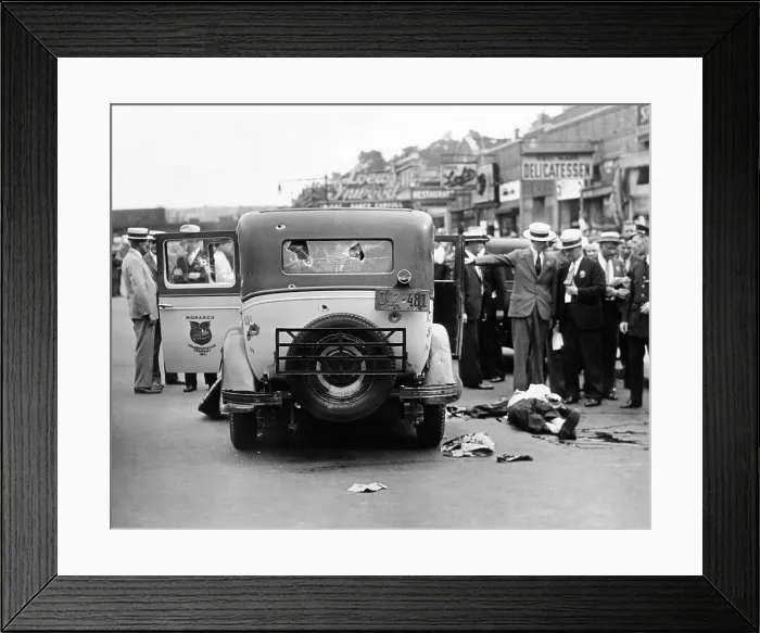 Framed Print : Detectives seek to identify the body of a slain gunman lying in the street beside a bullet ridden taxi Framed Print : Detectives seek to identify the body of a slain gunman lying in the street beside a bullet ridden taxi