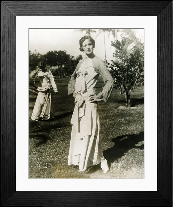Framed Print : The annual mid-winter Miami Beach fashion show displays a long dress with a touch of lace about the shoulders, giving it an air of old Spain. Ca. 1925-30
