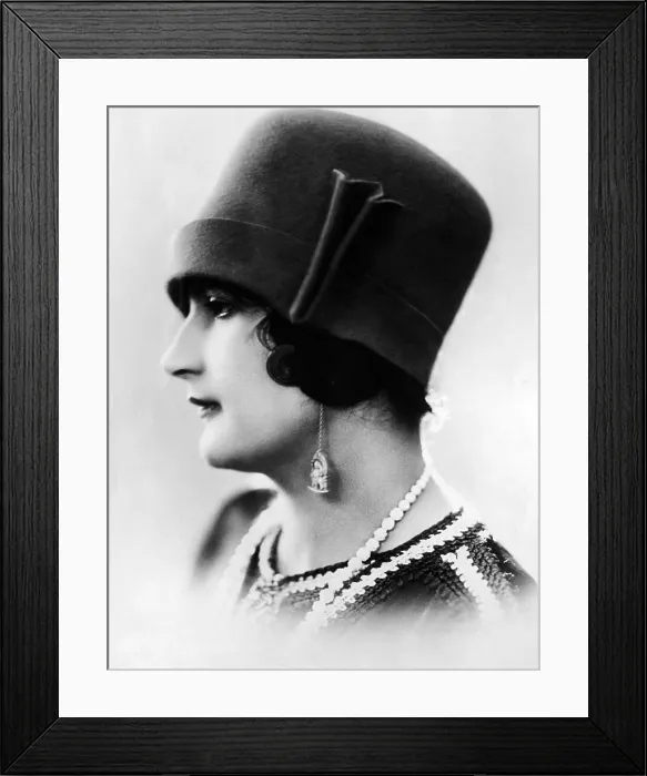 Framed Print : 1927 felt cloche hat from Paris. The name cloche means bell in French. The turned up brim frames the models short curls Framed Print : 1927 felt cloche hat from Paris. The name cloche means bell in French. The turned up brim frames the models short curls