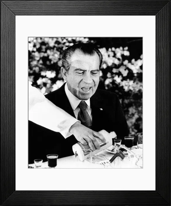 Framed Print : President Richard Nixon at a Chinese banquet. He watches as his glass is re-filled with Mao-tai, the potent alcoholic beverage used for the numerous toasts. Feb. 27, 1972