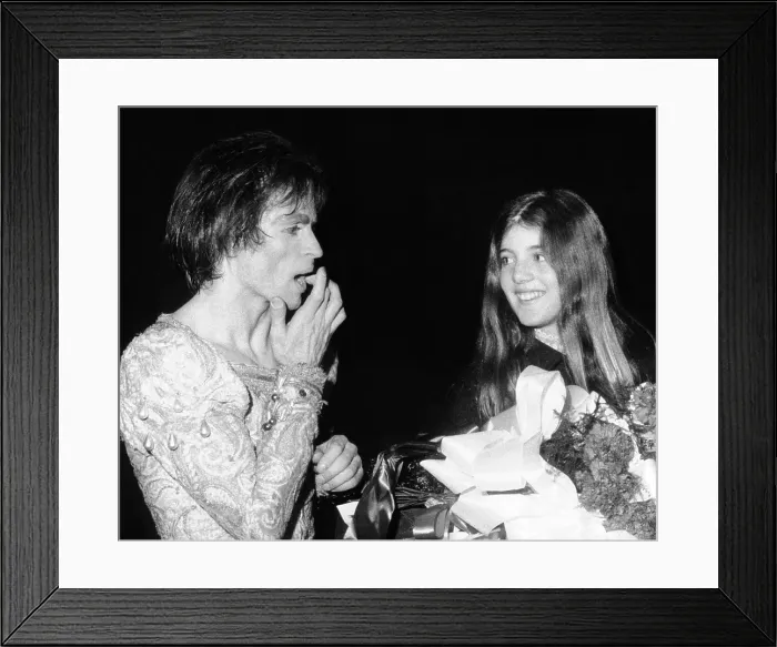 Framed Print : Ballet star Rudolph Nureyev treats a small cut on his finger caused by a thorn on the roses held by Caroline Kennedy