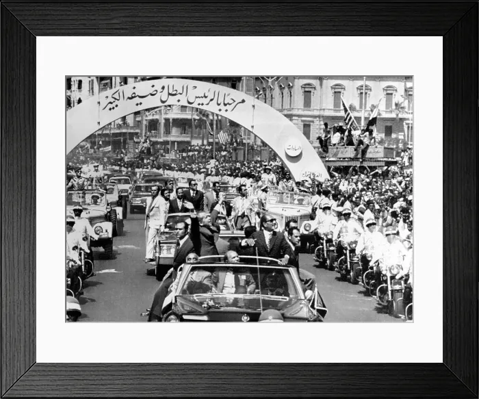 Framed Print : President Richard Nixon and President Sadat parade in Alexandria, Egypt. The arch reads in Arabic, Welcome Leader and his Great Guest. June 13, 1974