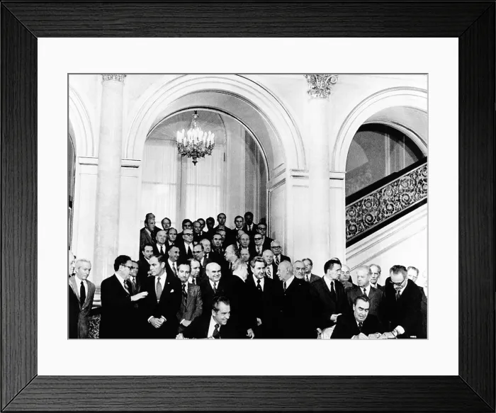 Framed Print : President Richard Nixon (seated left), watches Soviet Party leader, Leonid Brezhnev sign a ten year trade agreement. Standing at left, US Secy