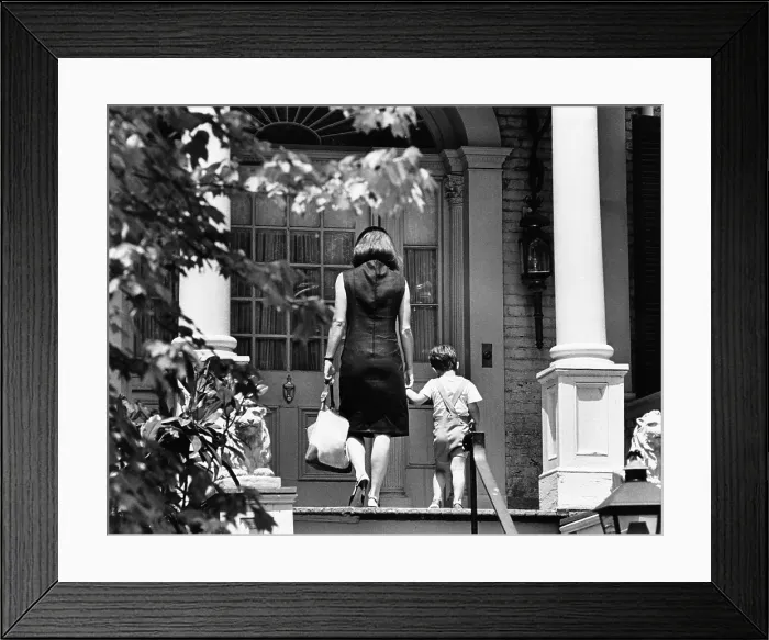 Framed Print : Jacqueline Kennedy and her son, 3 year old John F, Kennedy Jr. entering their Georgetown Federal era home