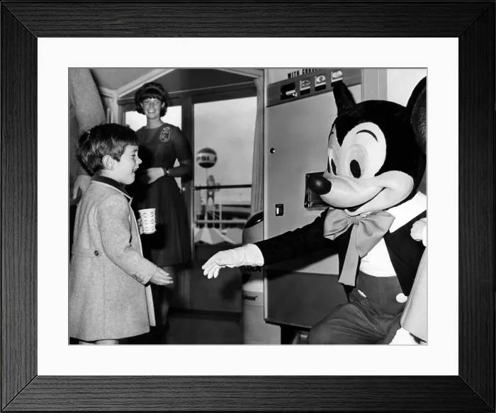 Framed Print : John F. Kennedy Jr. reaches out to shake hands with Mickey Mouse during a visit to the Pepsi Cola Pavilion at the New York World's Fair. April 24, 1965 Framed Print : John F. Kennedy Jr. reaches out to shake hands with Mickey Mouse during a visit to the Pepsi Cola Pavilion at the New York World's Fair. April 24, 1965