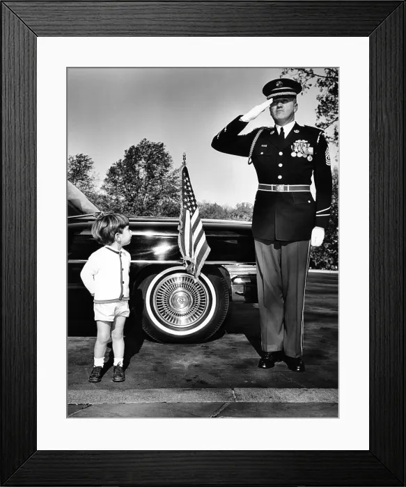 Framed Print : John F. Kennedy Jr. look up at Sgt. Eldon J. Johnston, during Veteran's Day ceremonies at Arlington National Cemetery. Nov. 11, 1963
