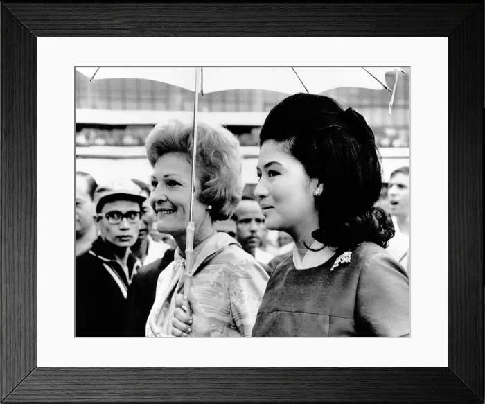 Framed Print : First Lady Pat Nixon (left) and Imelda Marcos stand under an umbrella at Manila airport Framed Print : First Lady Pat Nixon (left) and Imelda Marcos stand under an umbrella at Manila airport