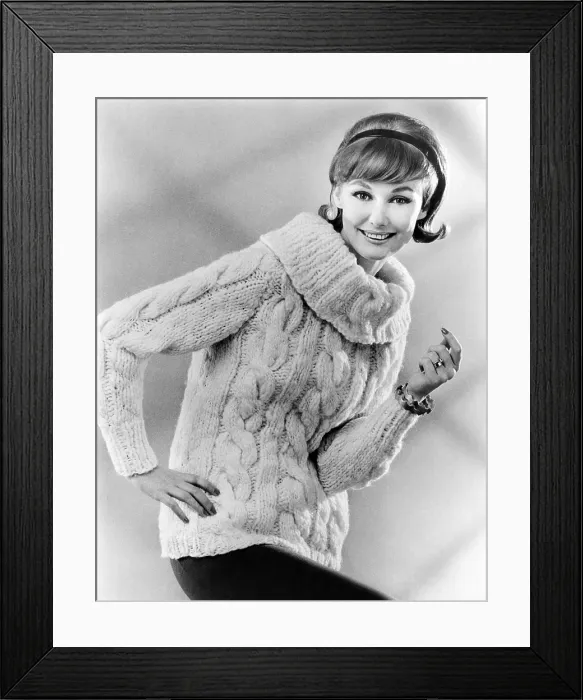 Framed Print : Sweater with a large cowl neck. The model's hair style has bangs, discreet bouffant, and flipped up ends