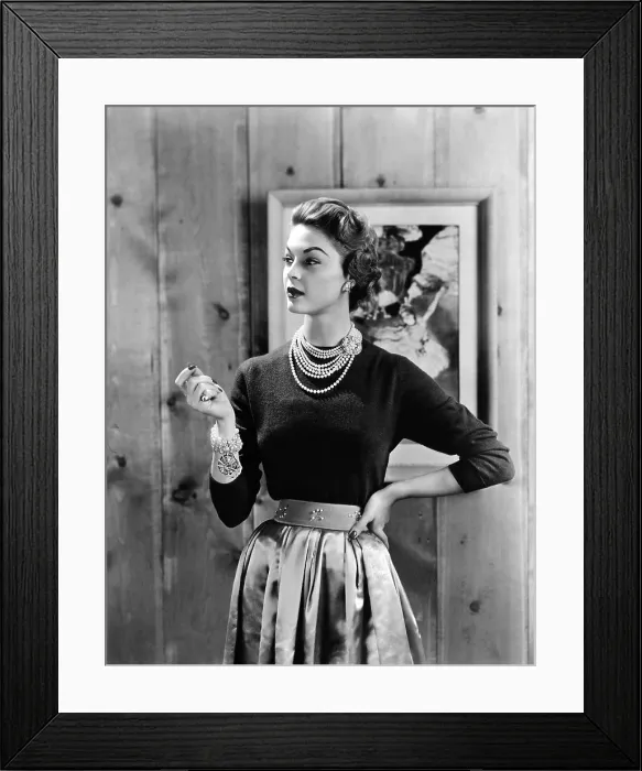 Framed Print : Black cashmere pullover is worn with a satin gathered full skirt and wide belt emphasizing the narrow waist Framed Print : Black cashmere pullover is worn with a satin gathered full skirt and wide belt emphasizing the narrow waist