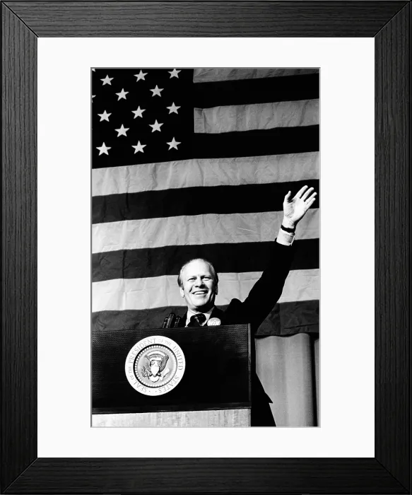 Framed Print : President Gerald Ford waves in front of a large American flag. He was speaking at a $ 100-a-couple Republican Party dinner In Indianapolis. October 16, 1974 Framed Print : President Gerald Ford waves in front of a large American flag. He was speaking at a $ 100-a-couple Republican Party dinner In Indianapolis. October 16, 1974