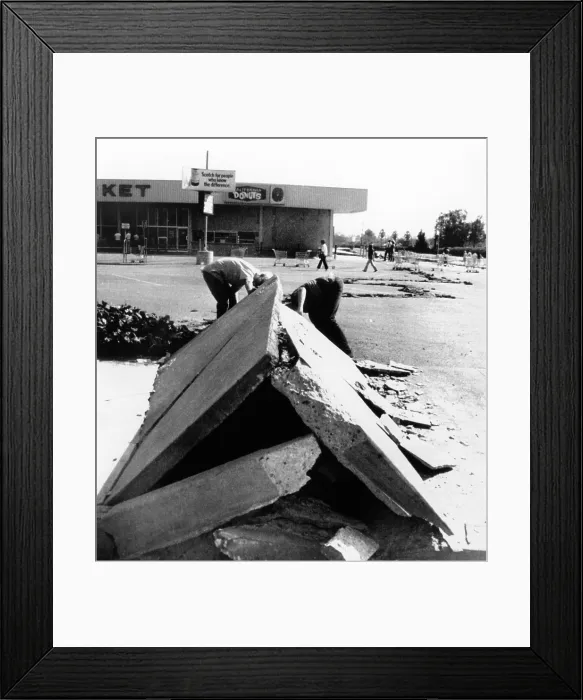 Framed Print : 1971 San Fernando Earthquake. Two boys look under a section of buckled concrete in downtown Sylmar, California. Feb. 9, 1971. (CSU_ALPHA_1341) CSU Archives / Everett Collection