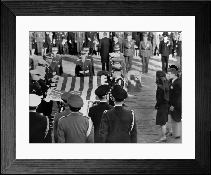 Framed Print : Jacqueline Kennedy stands forward as the flag from her husband's coffin is raised for folding