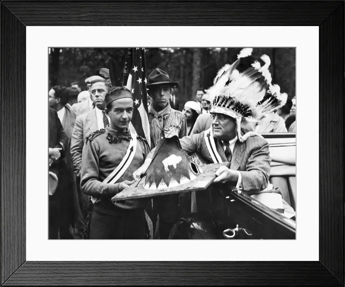 Framed Print : President Franklin Roosevelt in a war bonnet. FDR wears Indian headdress as he receives a miniature Native American teepee from a Boy Scout. Aug. 23, 1933
