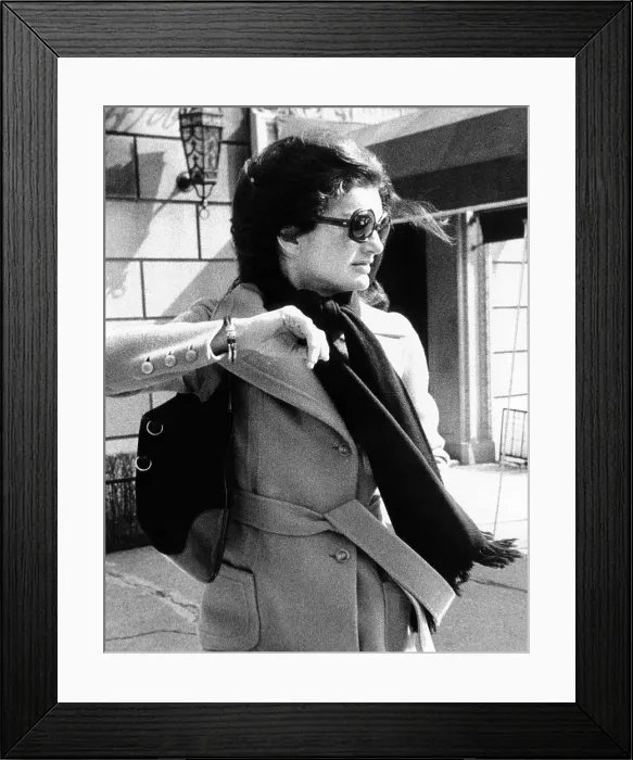 Framed Print : Jacqueline Kennedy Onassis, a recently widowed for a second time, turns her head and raises her arm to avoid a photographer as she leaves her New York apartment building Framed Print : Jacqueline Kennedy Onassis, a recently widowed for a second time, turns her head and raises her arm to avoid a photographer as she leaves her New York apartment building