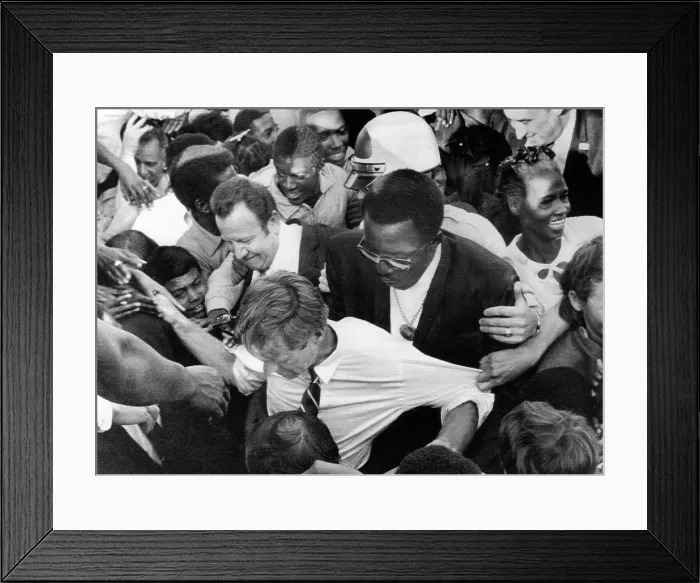 Framed Print : Sen. Robert Kennedy tugged at from every direction