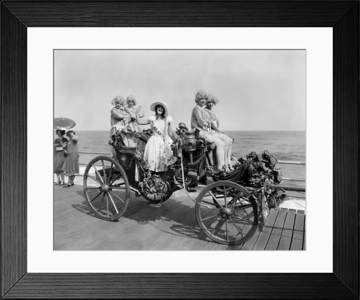Framed Print : Miss Atlantic City waves from the her carriage on the boardwalk. Her she is attended by feminine footmen in silk stocking and blond wigs. Sept. 1925