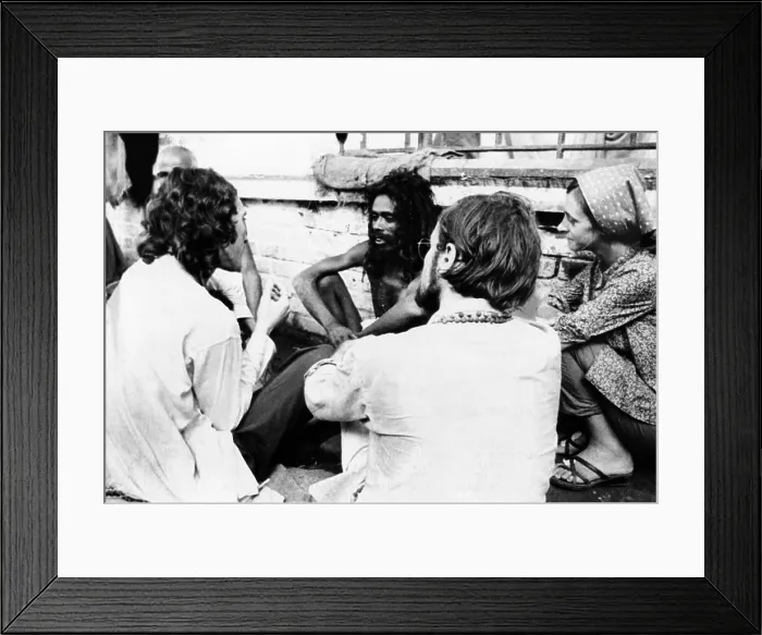 Framed Print : American hippies in Katmandu, Nepal. They talk with an Indian Sadhu, a Hindu Holy man, on a rooftop. The hippie community in Nepal ranged was estimated to be between 70 and 100