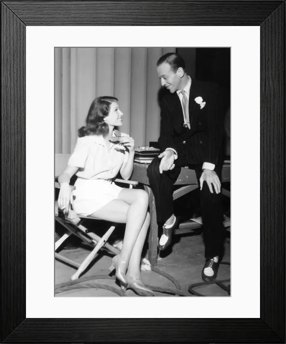 Framed Print : From left: co-stars Rita Hayworth and Fred Astaire relax between takes of YOU'LL NEVER GET RICH, 1941