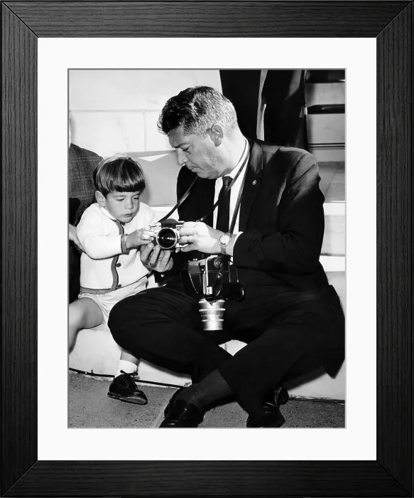 Framed Print : John F. Kennedy Jr. takes an interest in the cameras of White House photographer Capt. Cecil Stoughton. Nov. 11, 1963. (CSU_ALPHA_902) CSU Archives / Everett Collection