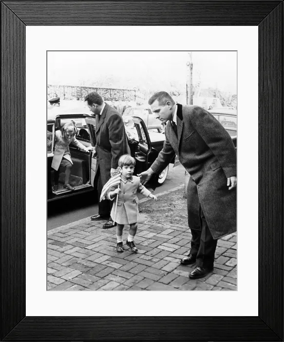 Framed Print : Young John and Caroline Kennedy with Secret Service men as they enter their temporary home after leaving the White House