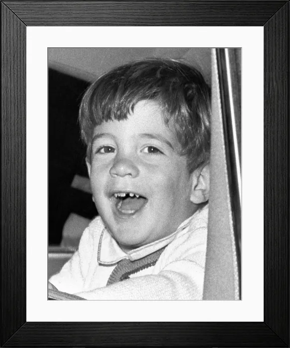 Framed Print : John Kennedy Jr. smiles from the President's limousine following ceremonies on Veterans Day at Arlington National Cemetery. Nov. 11, 1963