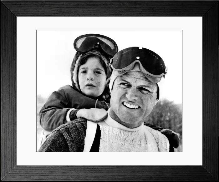 Framed Print : Ted Kennedy gives his nephew John F. Kennedy Jr. a piggy-back ride down the ski slopes in Stowe, Vermont. The Kennedy family spent Easter weekend skiing together. March 29, 1964