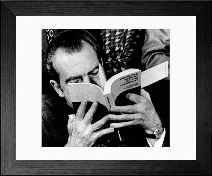 Framed Print : President Richard Nixon takes a close look at his economic report to Congress during the signing ceremony at the White House. Feb. 1, 1974
