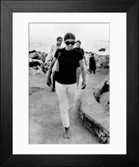 Framed Print : Jacqueline Kennedy Onassis on vacation in Capri, Italy. A barefooted Mrs. Jacqueline Onassis walks along the dock of this island resort. Behind her is her sister Lee Radziwill Framed Print : Jacqueline Kennedy Onassis on vacation in Capri, Italy. A barefooted Mrs. Jacqueline Onassis walks along the dock of this island resort. Behind her is her sister Lee Radziwill