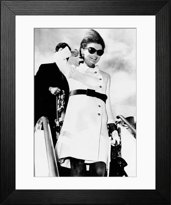 Framed Print : Jacqueline Kennedy, wearing a white coat dress with a short skirt. She deplanes in Rome following a 10-day Asian holiday. Nov. 11, 1967