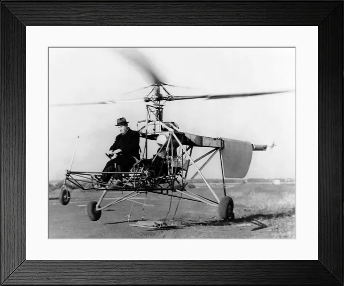 Framed Print : Igor Sikorsky at the controls of the VS-300 helicopter. It lifts off the ground on one of its early test flights in Sep. 1939