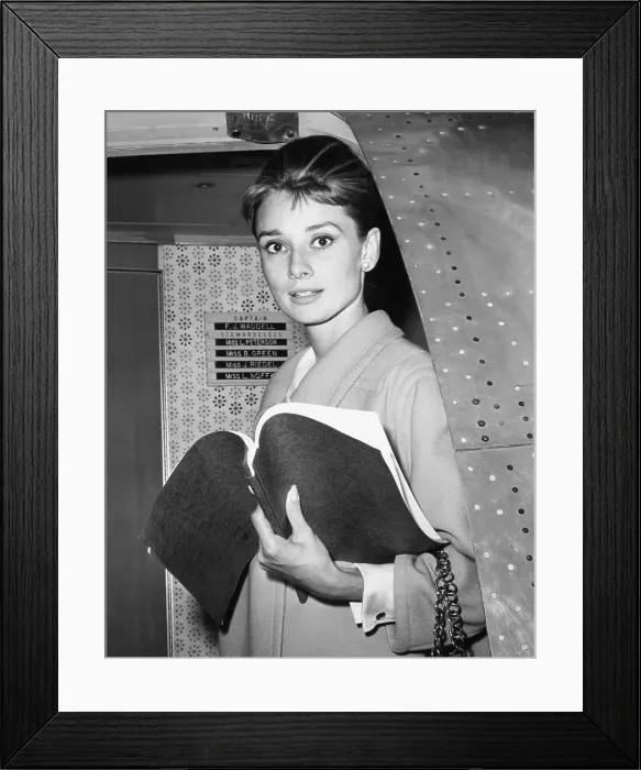 Framed Print : Audrey Hepburn, with her script for BREAKFAST AT TIFFANY'S, returning to Los Angeles from New York location filming, October 1960