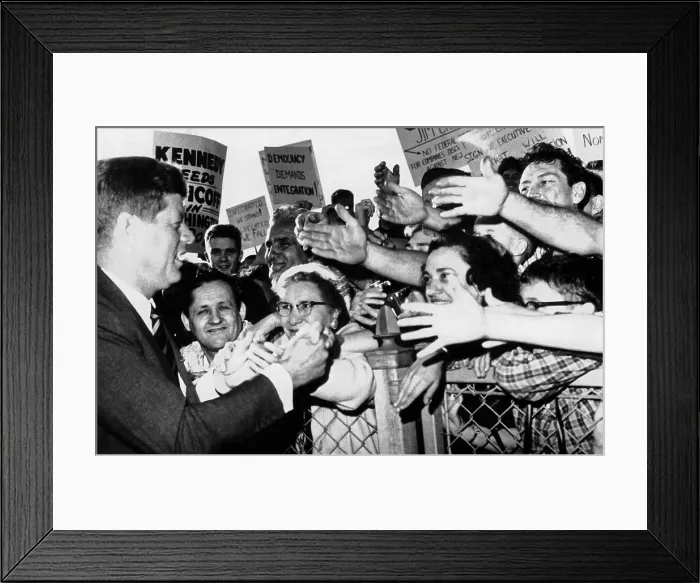 Framed Print : President John Kennedy greets well-wishers. JFK shakes hands at the Bridgeport, Connecticut airport while campaigning for Democratic candidates in the mid-term election. Oct
