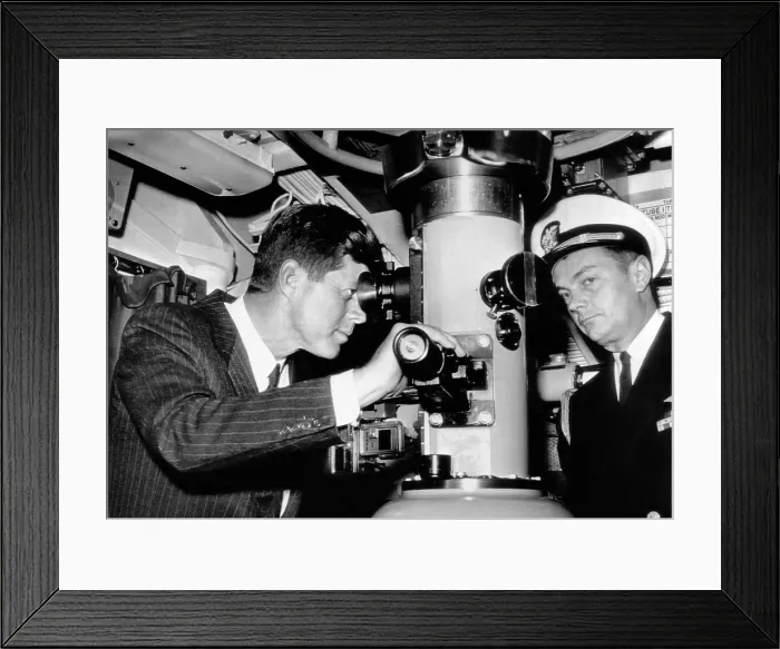 Framed Print : President John Kennedy looks through the periscope of the nuclear submarine USS Thomas A. Edison. At right is his Naval Aide, Capt. Tazewell Shepard