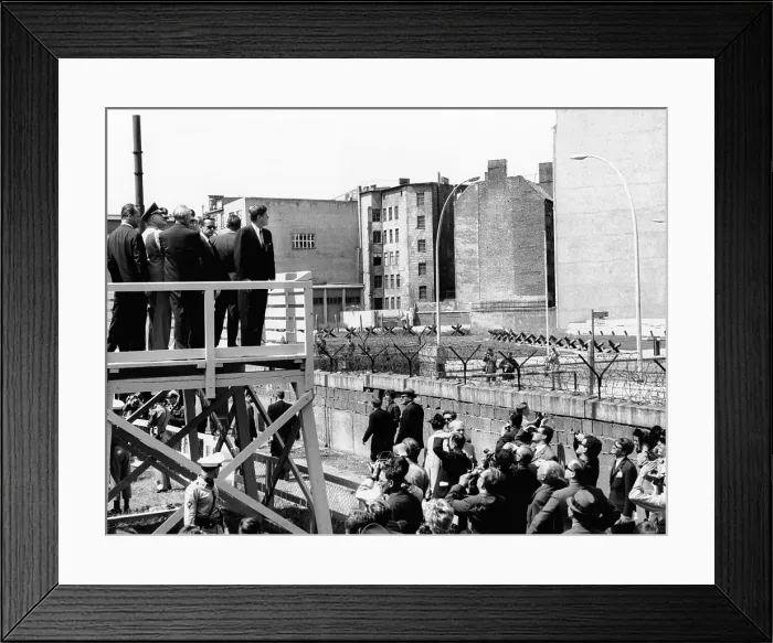 Framed Print : President John Kennedy in Berlin. On a specially erected platform, JFK views the communist wall which separates East and West Berlin. July 26, 1963 Framed Print : President John Kennedy in Berlin. On a specially erected platform, JFK views the communist wall which separates East and West Berlin. July 26, 1963
