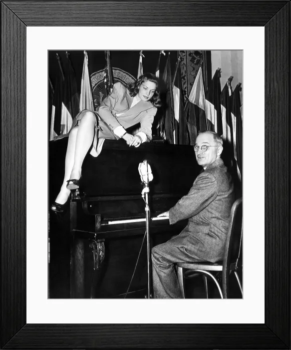 Framed Print : Actress Lauren Bacall sits atop the piano while Vice President Harry Truman plays Framed Print : Actress Lauren Bacall sits atop the piano while Vice President Harry Truman plays